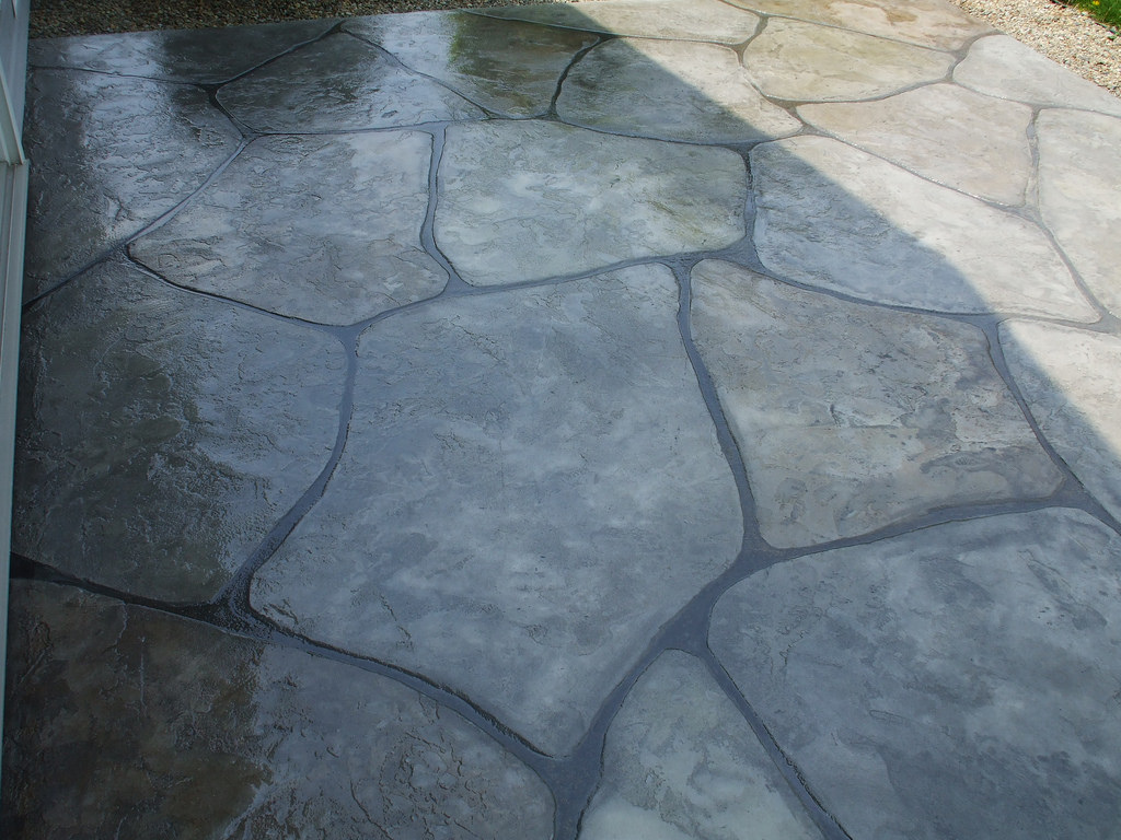 Picture of stamped concrete patio is concrete sealer to give a wet look.