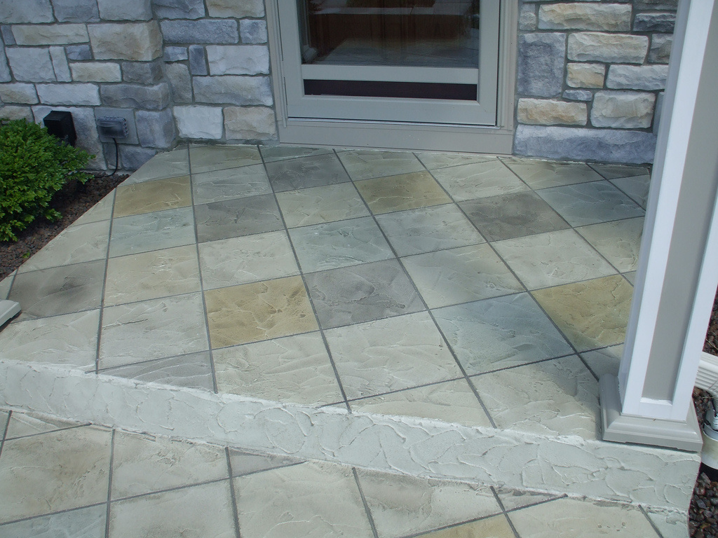 Front porch entry way with a stamped concrete finish.