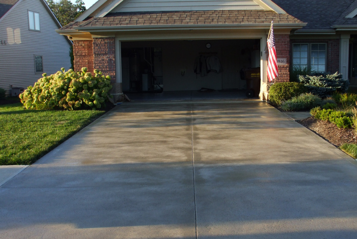 Picture of stained and died concrete driveway.