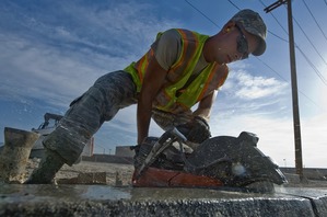 A concrete contractor cutting concrete.