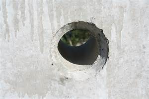 Picture of a concrete wall with a cored hole in the wall.